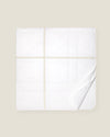 white quiltino with beige embroidery