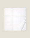 white quiltino with sage embroidery